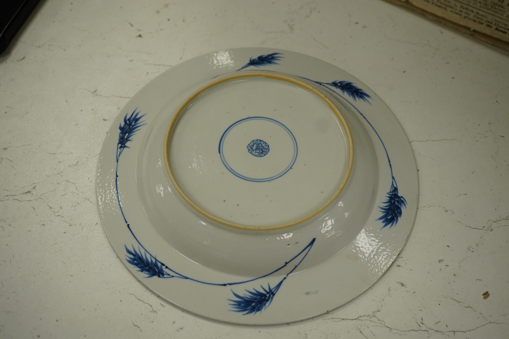 A Chinese powder blue plate, possibly Kangxi, with figurative central decoration, 22.5cm diameter. Condition - good